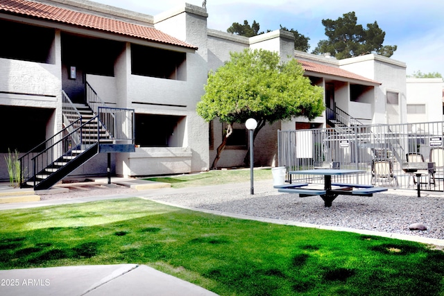 surrounding community with a lawn and stairway
