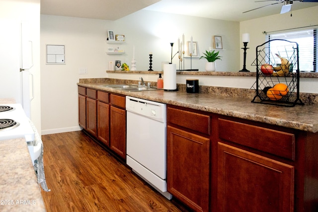 kitchen with white appliances, dark wood-style floors, a ceiling fan, dark countertops, and a sink