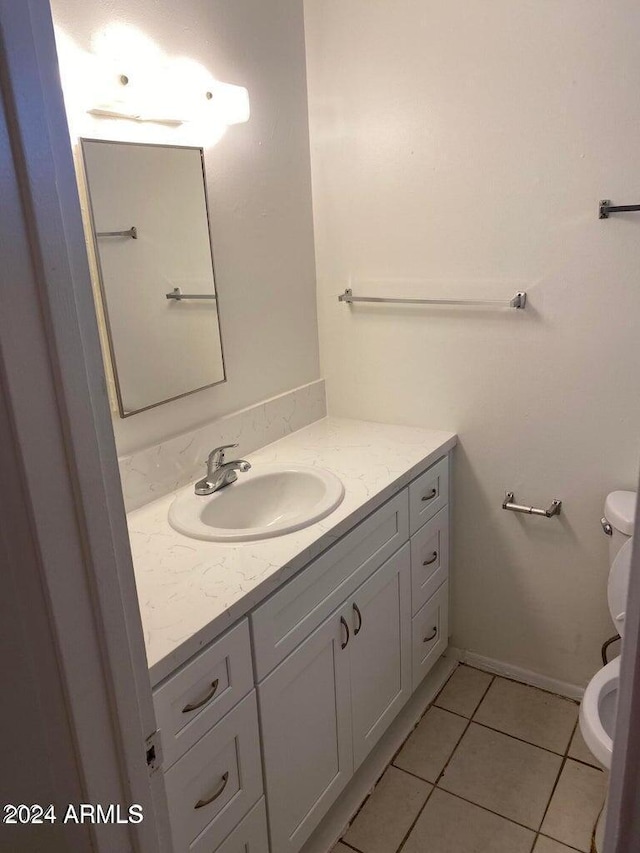 bathroom featuring tile patterned floors, vanity, and toilet