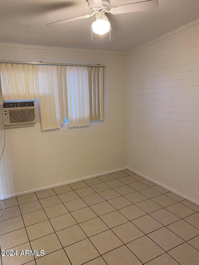 spare room featuring ceiling fan, brick wall, and a wall mounted AC