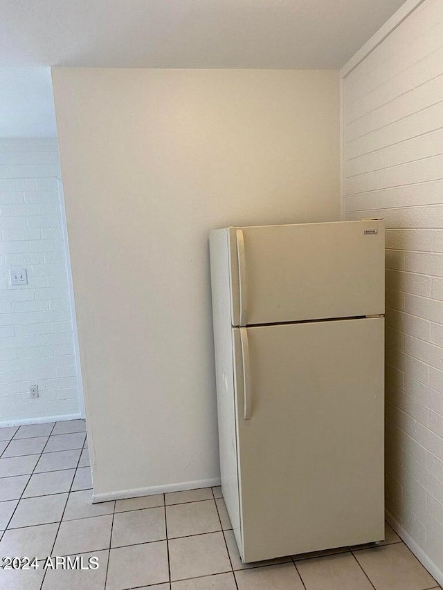 kitchen with white fridge and light tile patterned flooring