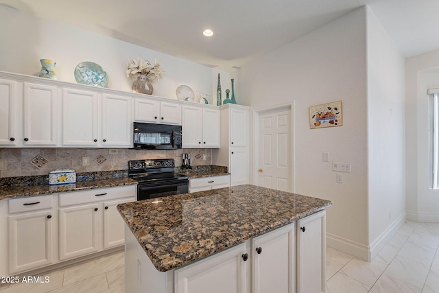 kitchen with a center island, dark stone countertops, white cabinets, and black appliances