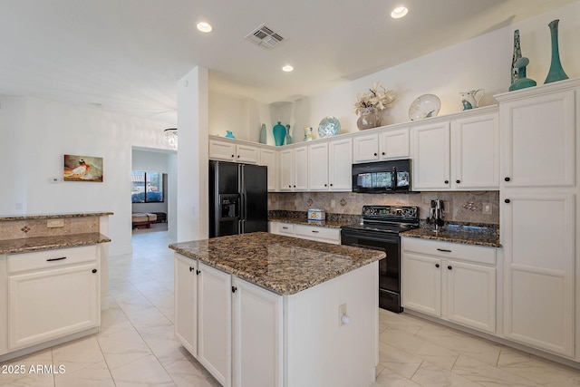 kitchen featuring white cabinetry, backsplash, dark stone countertops, a center island, and black appliances