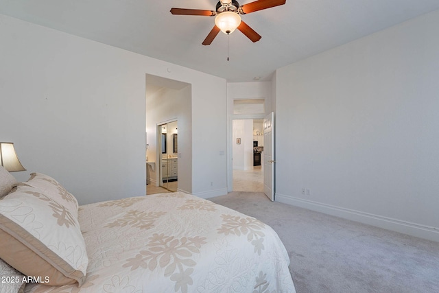 carpeted bedroom featuring ceiling fan and ensuite bathroom