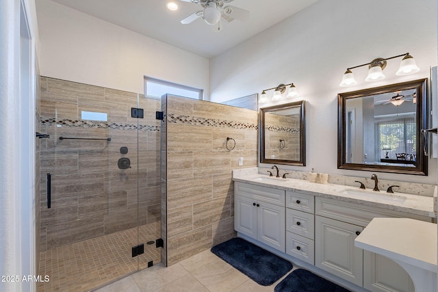 bathroom with an enclosed shower, vanity, tile patterned flooring, and ceiling fan