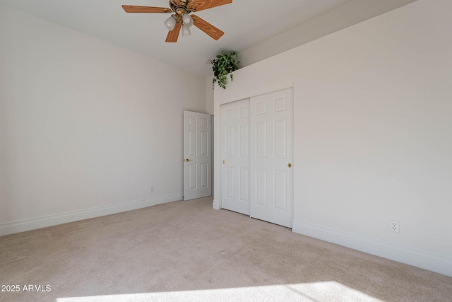 unfurnished bedroom featuring a closet and light carpet