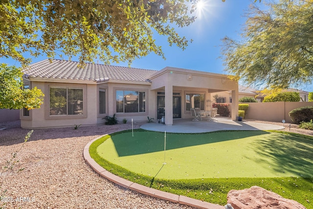 back of property with a patio