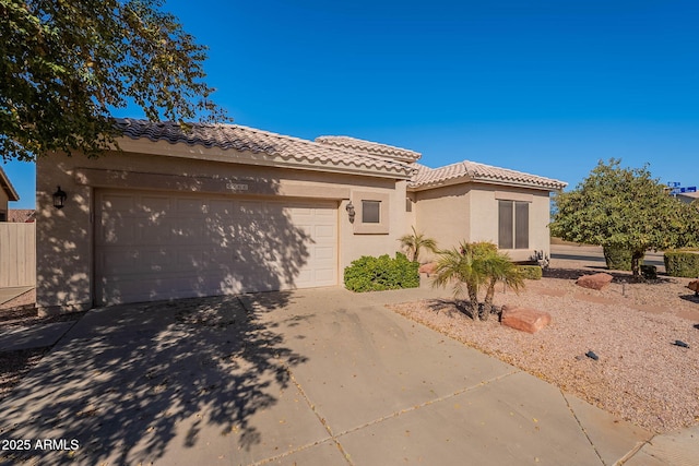 mediterranean / spanish-style home with a garage