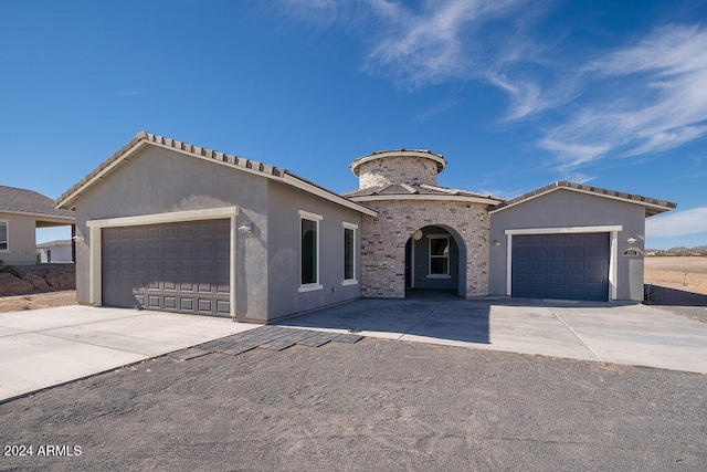 mediterranean / spanish-style house featuring a garage