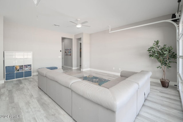 living room with ceiling fan and light wood-type flooring