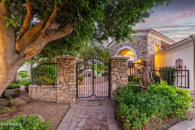 view of gate at dusk