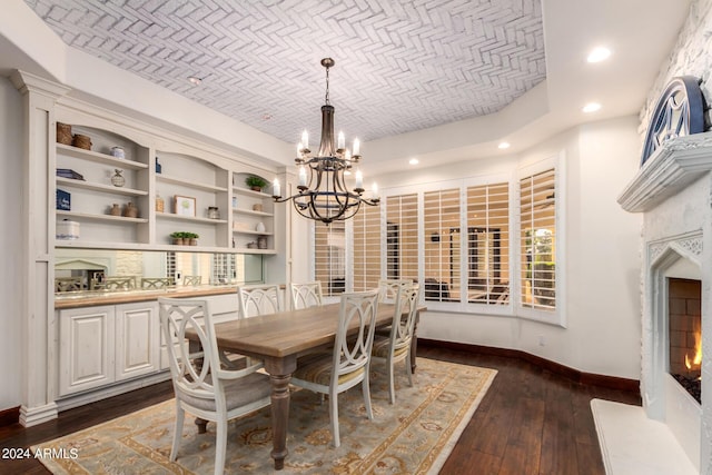 dining area with brick ceiling, dark wood-type flooring, and a chandelier