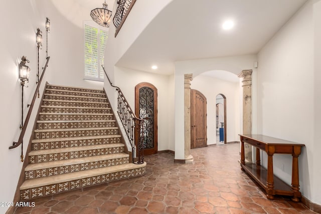 staircase featuring decorative columns