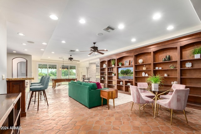 living room featuring ceiling fan and pool table