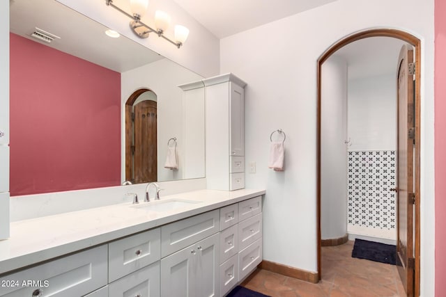 bathroom featuring tile patterned flooring and vanity