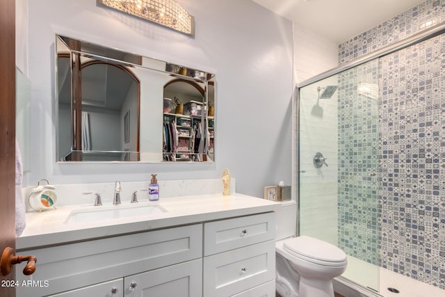 bathroom featuring toilet, vanity, and walk in shower