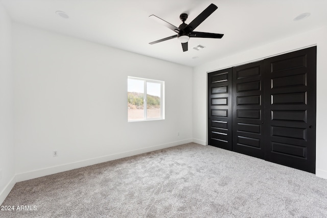 unfurnished bedroom featuring carpet flooring and ceiling fan