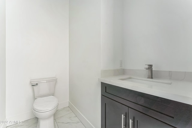 bathroom with toilet and vanity