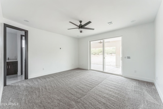 carpeted empty room featuring ceiling fan