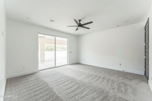 empty room with ceiling fan and light colored carpet