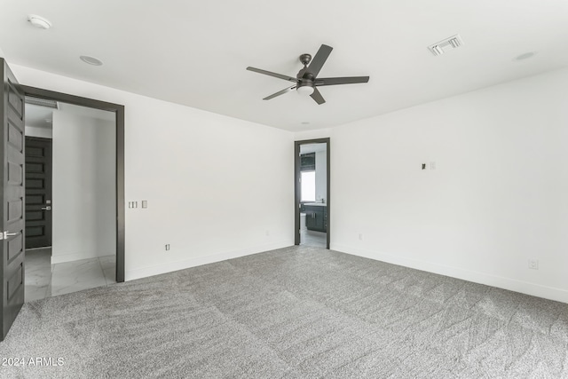 carpeted spare room featuring ceiling fan