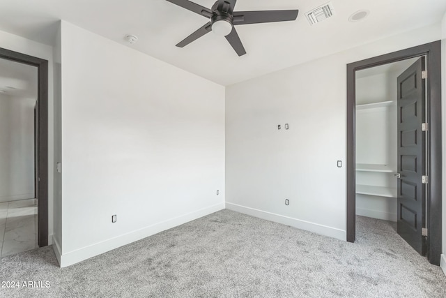 spare room with light carpet and ceiling fan