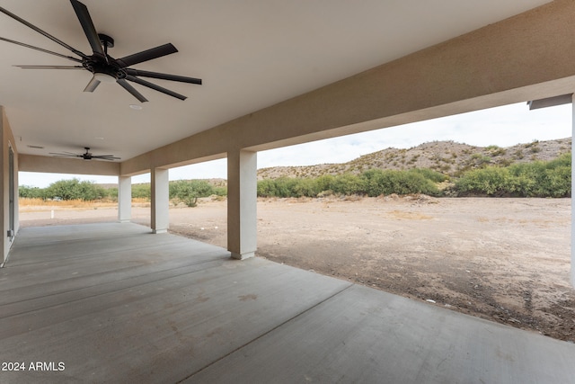 view of patio / terrace with a mountain view and ceiling fan