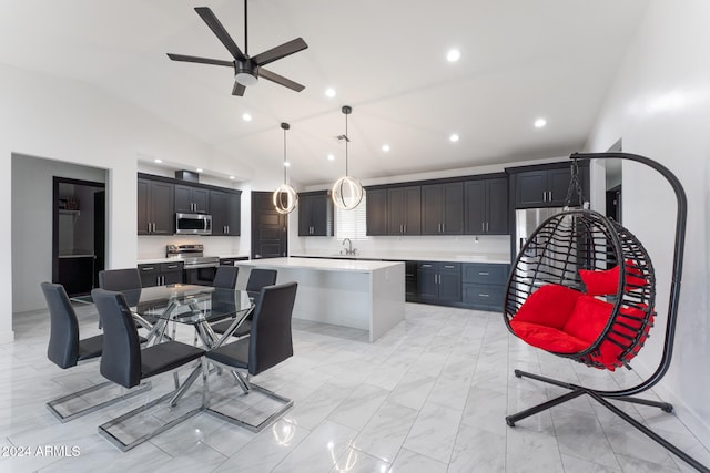 kitchen with stainless steel appliances, a center island, vaulted ceiling, sink, and pendant lighting