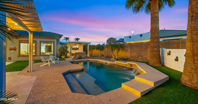 pool at dusk with a patio area, a fenced backyard, and a fenced in pool