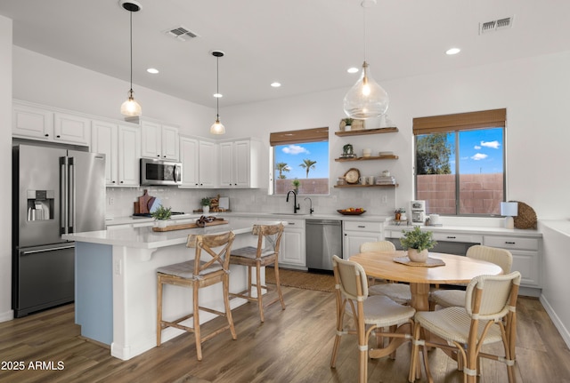 kitchen featuring visible vents, backsplash, and appliances with stainless steel finishes