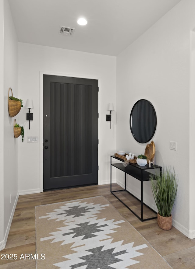 entrance foyer featuring recessed lighting, visible vents, baseboards, and wood finished floors