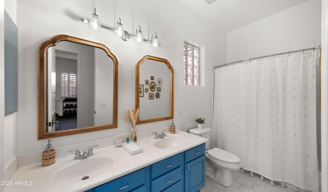 full bath with tile patterned flooring, double vanity, toilet, and a sink