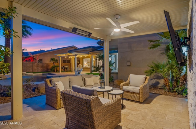 patio terrace at dusk featuring an outdoor living space, fence, a fenced in pool, and ceiling fan