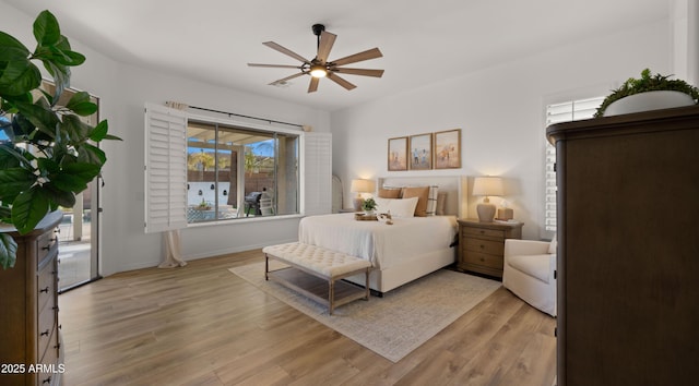 bedroom featuring baseboards, light wood-style floors, and a ceiling fan