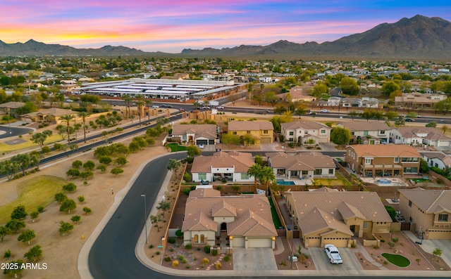 aerial view at dusk with a mountain view and a residential view