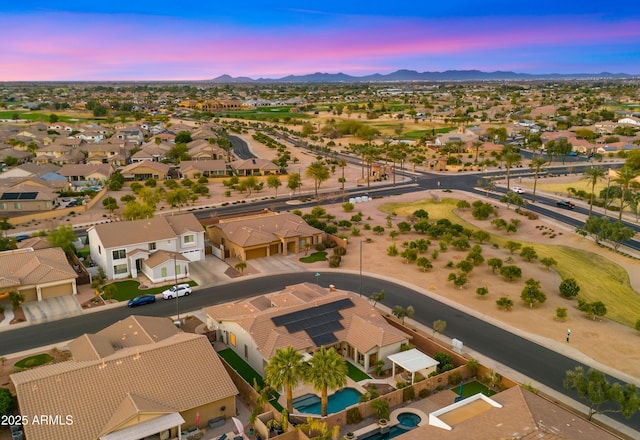 aerial view at dusk with a residential view and a mountain view