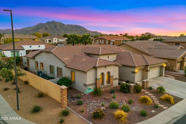 view of front facade featuring a mountain view, a residential view, and an attached garage