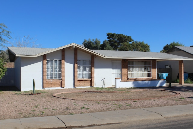 single story home featuring concrete block siding
