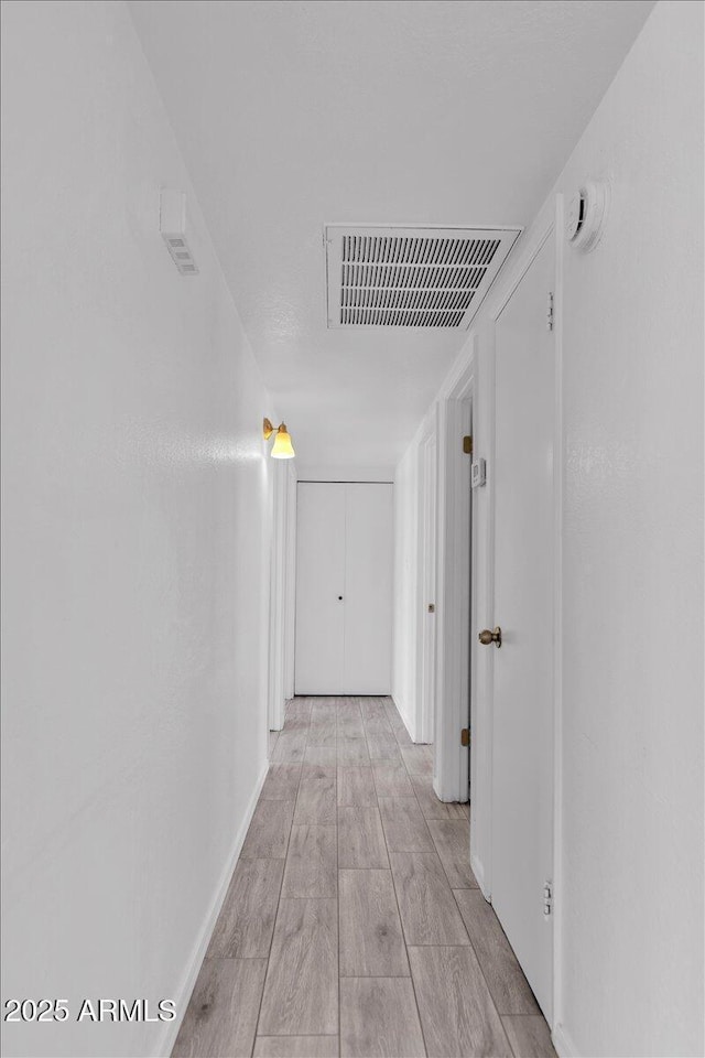 corridor with visible vents and light wood-type flooring