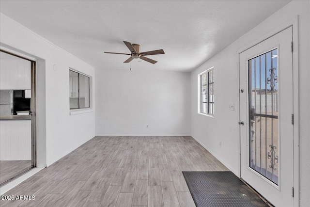 entrance foyer featuring light wood-style floors and ceiling fan