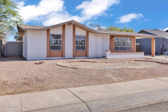 ranch-style home with fence