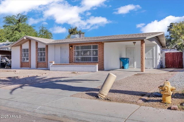 single story home with fence and an attached carport