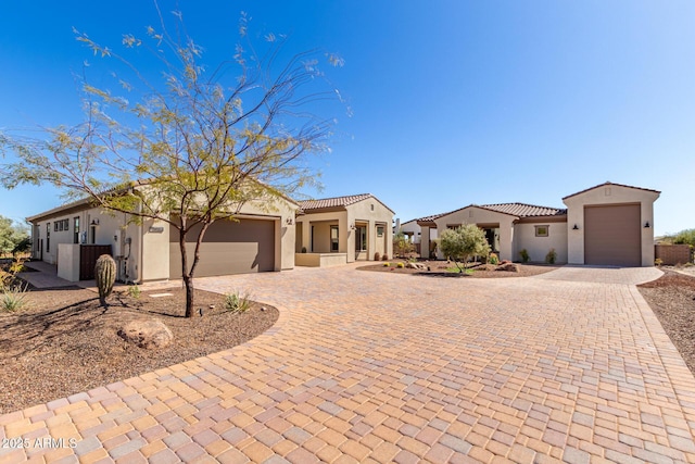 3940 Rolling Stock Way, Wickenburg, AZ 85390 - view of front of home with a tile roof, an attached garage, decorative driveway, and stucco siding