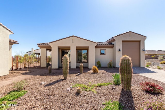 3940 Rolling Stock Way, Wickenburg, AZ 85390 - mediterranean / spanish home with stucco siding, driveway, a tile roof, a garage, and fence