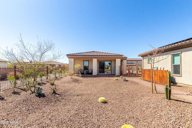 3940 Rolling Stock Way, Wickenburg, AZ 85390 - rear view of property with stucco siding, a tiled roof, and fence