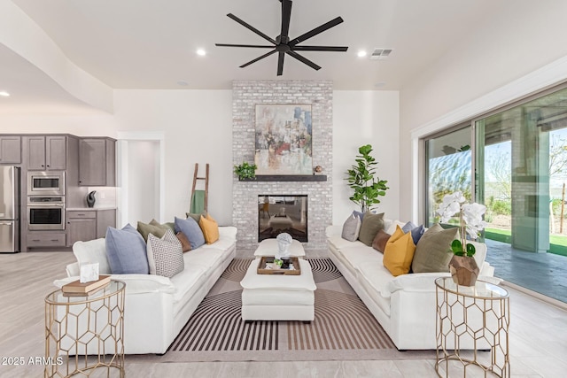 3940 Rolling Stock Way, Wickenburg, AZ 85390 - living room featuring recessed lighting, a fireplace, visible vents, and ceiling fan