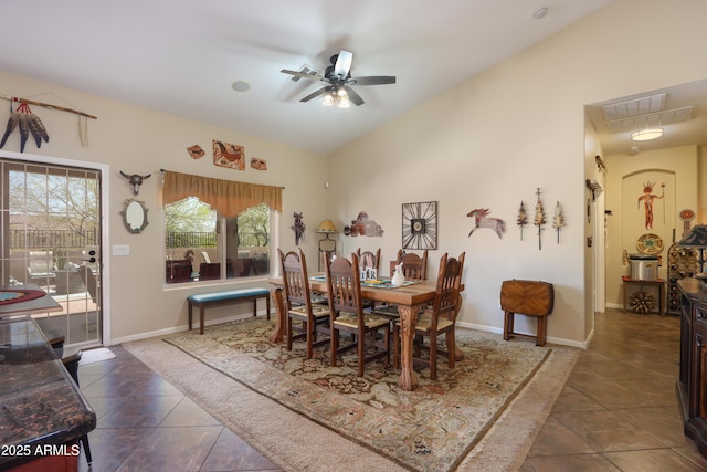 tiled dining space featuring vaulted ceiling and ceiling fan