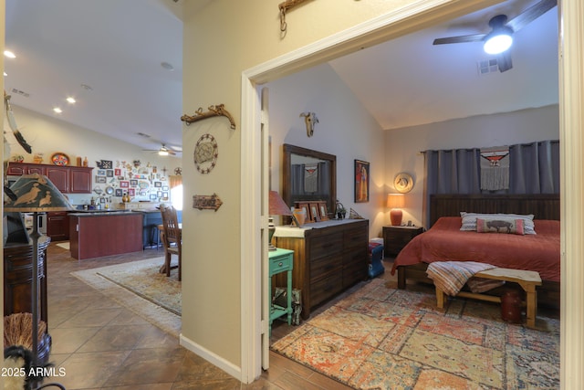 bedroom featuring dark tile patterned floors, vaulted ceiling, and ceiling fan