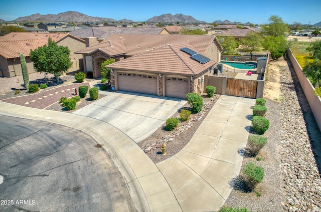 single story home with a mountain view and a garage