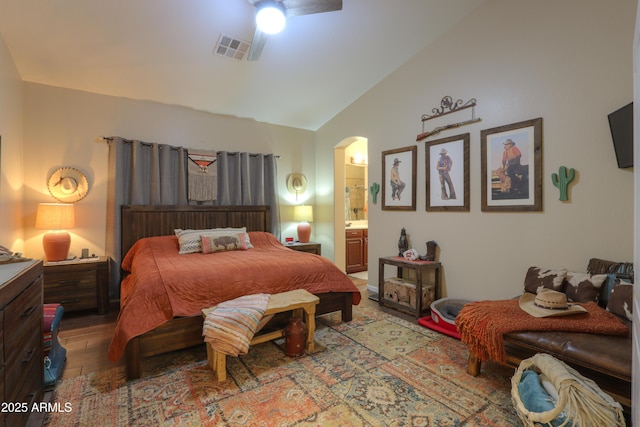 bedroom with wood-type flooring, vaulted ceiling, ceiling fan, and ensuite bathroom